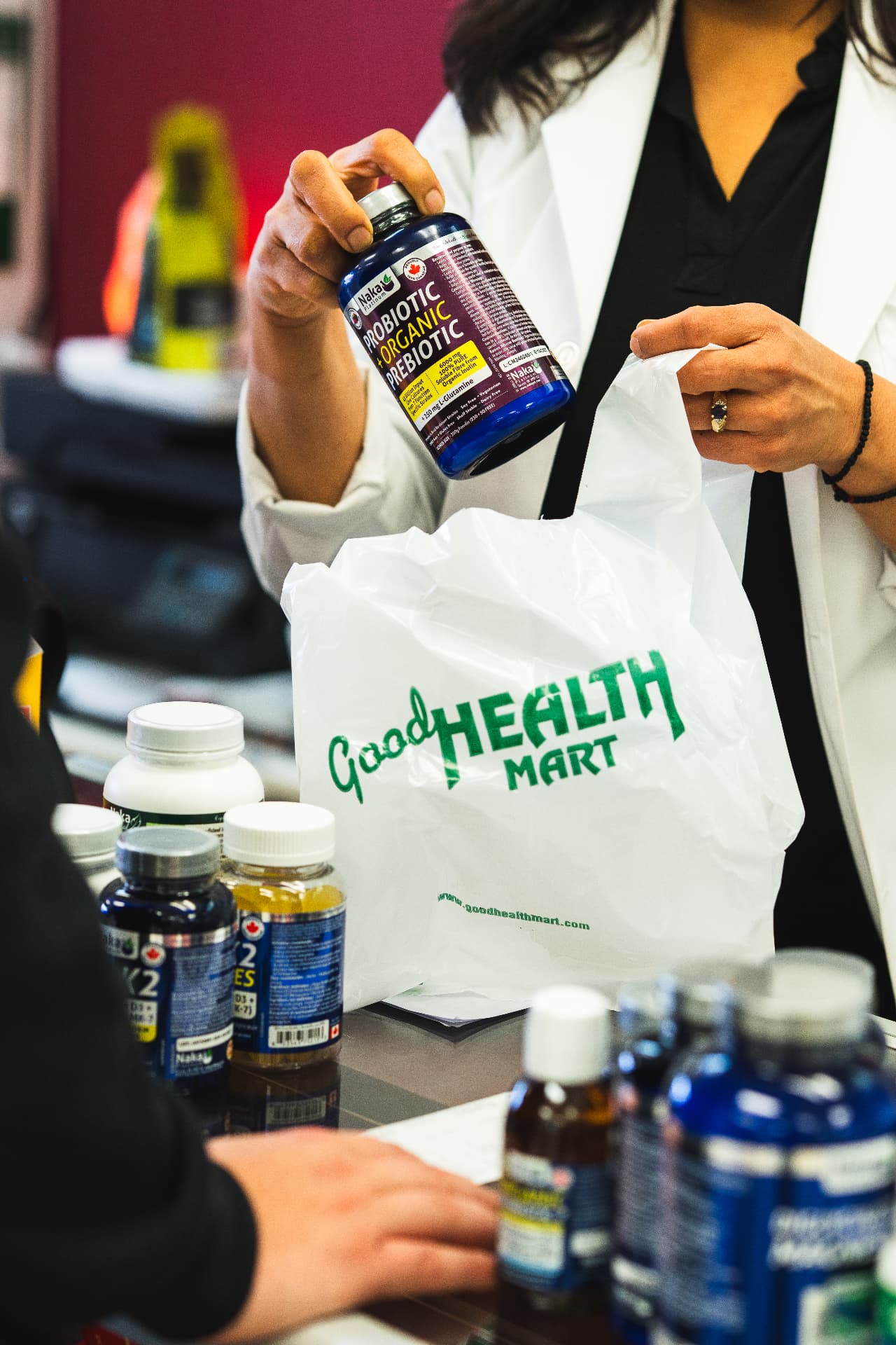Good Health Mart staff bagging supplements for a customer